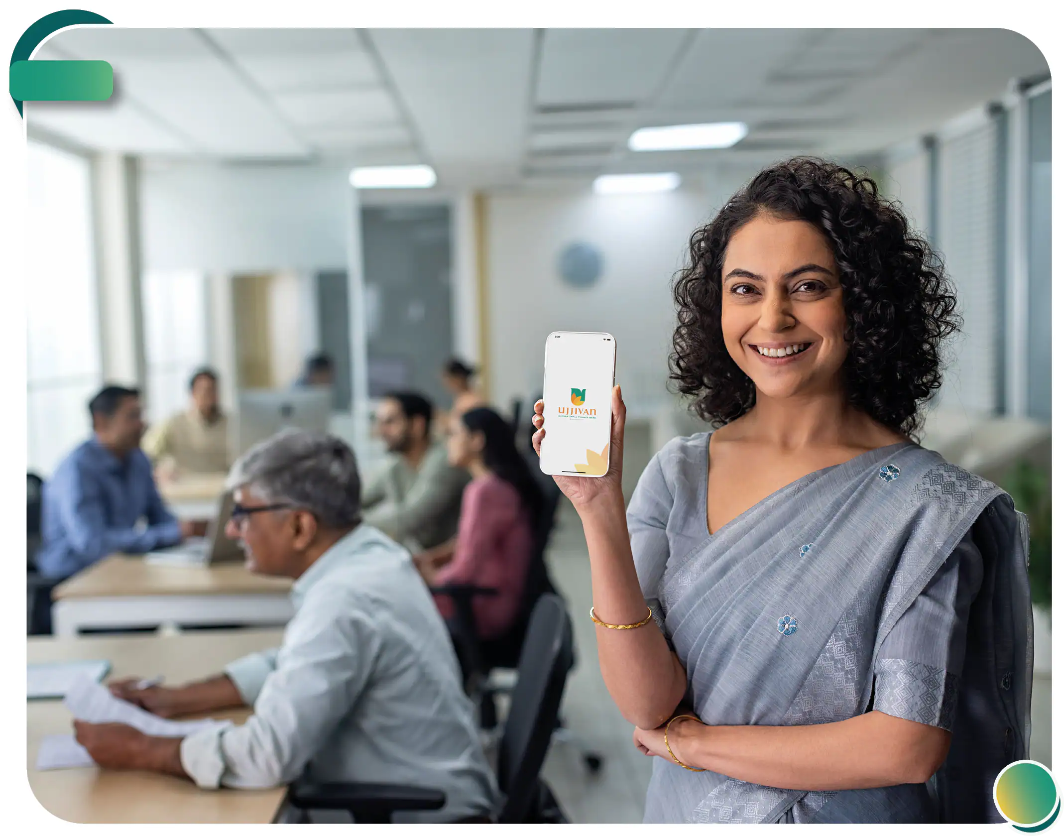 woman showing a phone with UJJIVAN app.